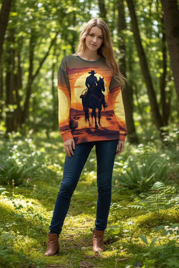 Woman wearing a sweater with a horse and rider design in a forest setting