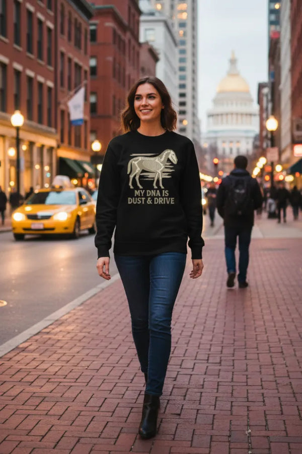 Woman wearing a black sweatshirt with text and graphics on a city street.