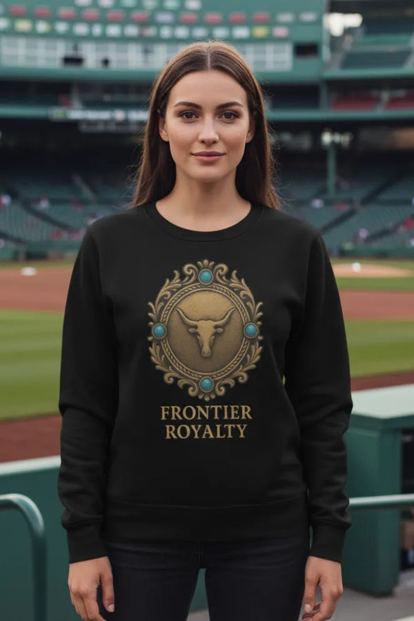 Woman wearing a black sweatshirt with 'Frontier Royalty' logo on a baseball field background