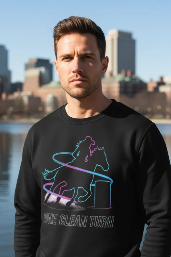 Man wearing a black sweatshirt with a colorful horse graphic and text, standing by a waterfront with city skyline in the background.