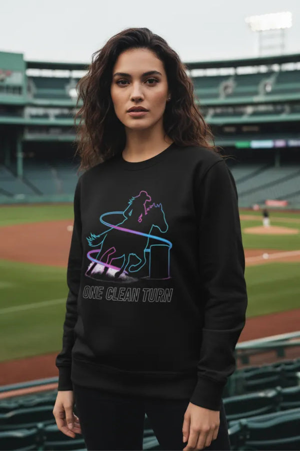 Woman wearing a black sweatshirt with a graphic design on a baseball field