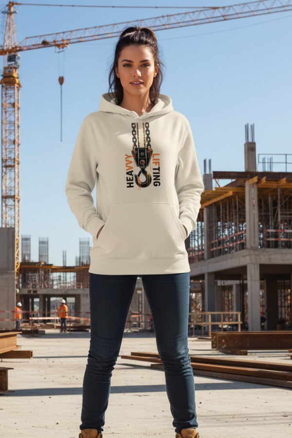 Woman wearing a hoodie with a construction-themed graphic in an industrial setting