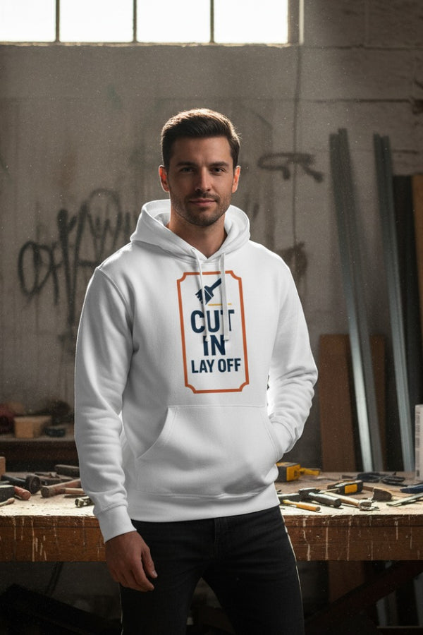 Man wearing a white hoodie with a graphic design in an industrial setting