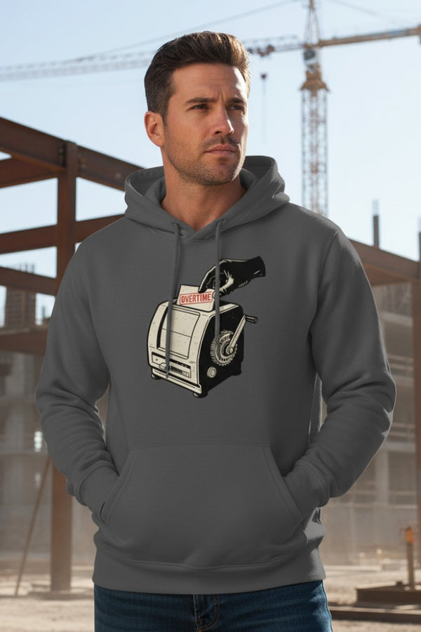 Man wearing a gray hoodie with a graphic design of a gun and magazine, standing in an outdoor setting.