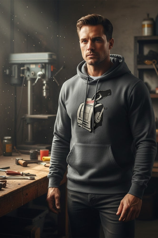 Man wearing a hoodie with a graphic design in a workshop setting