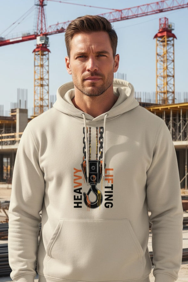 Man wearing a beige hoodie with 'Heavy Lifting' graphic in an urban setting