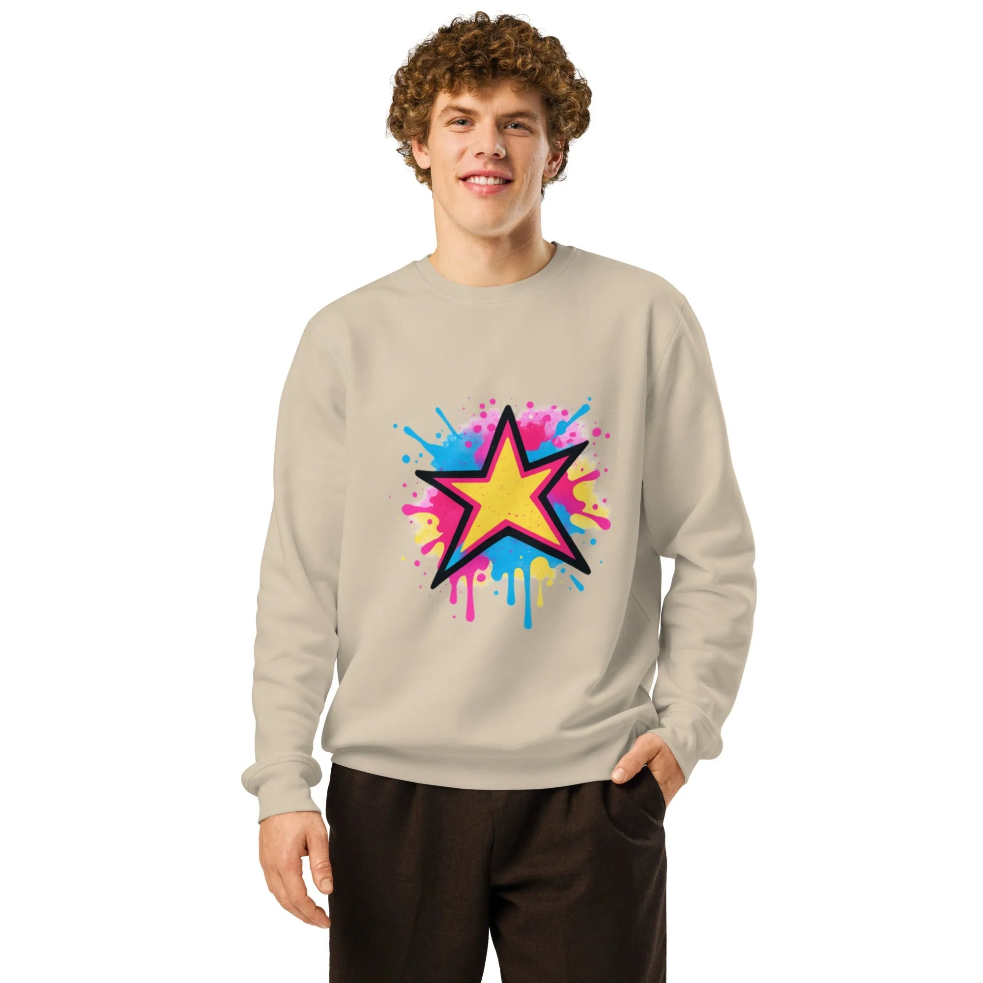 Faded charcoal sweatshirt with vibrant, splattered neon paint under stark, overhead lighting.