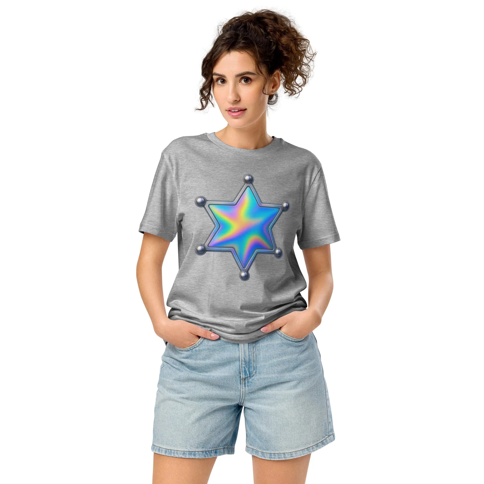 A holographic sheriff star patch on a faded, worn cotton t-shirt, lit by a low, warm sun.
