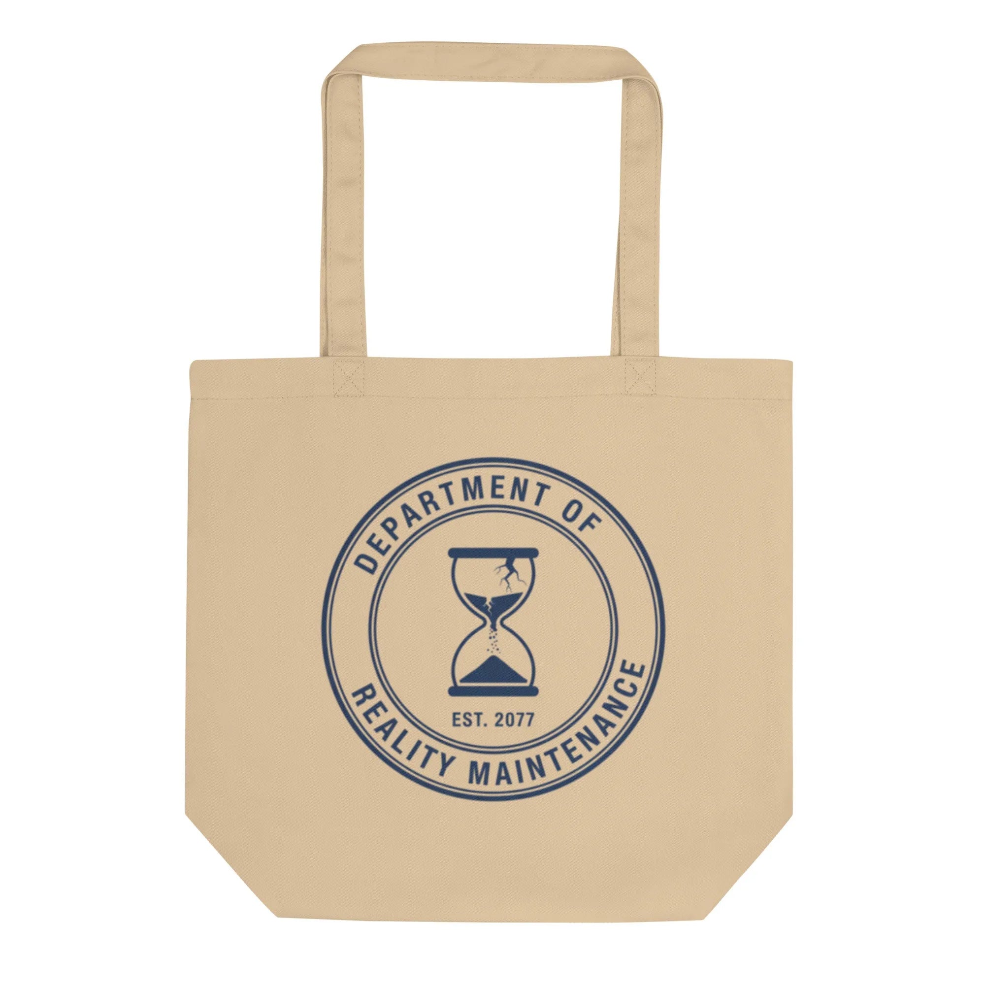 Worn GOTS cotton tote bag, sun-faded canvas, casting a sharp shadow on concrete.
