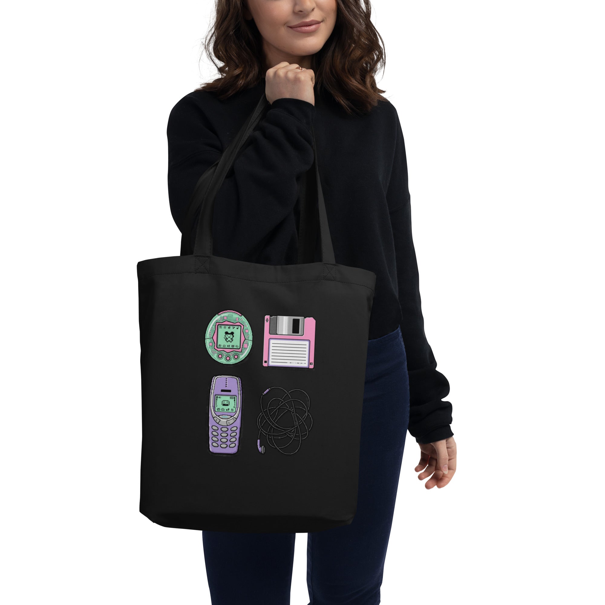 Black canvas tote bag, worn handle, harsh overhead light casting deep shadow.