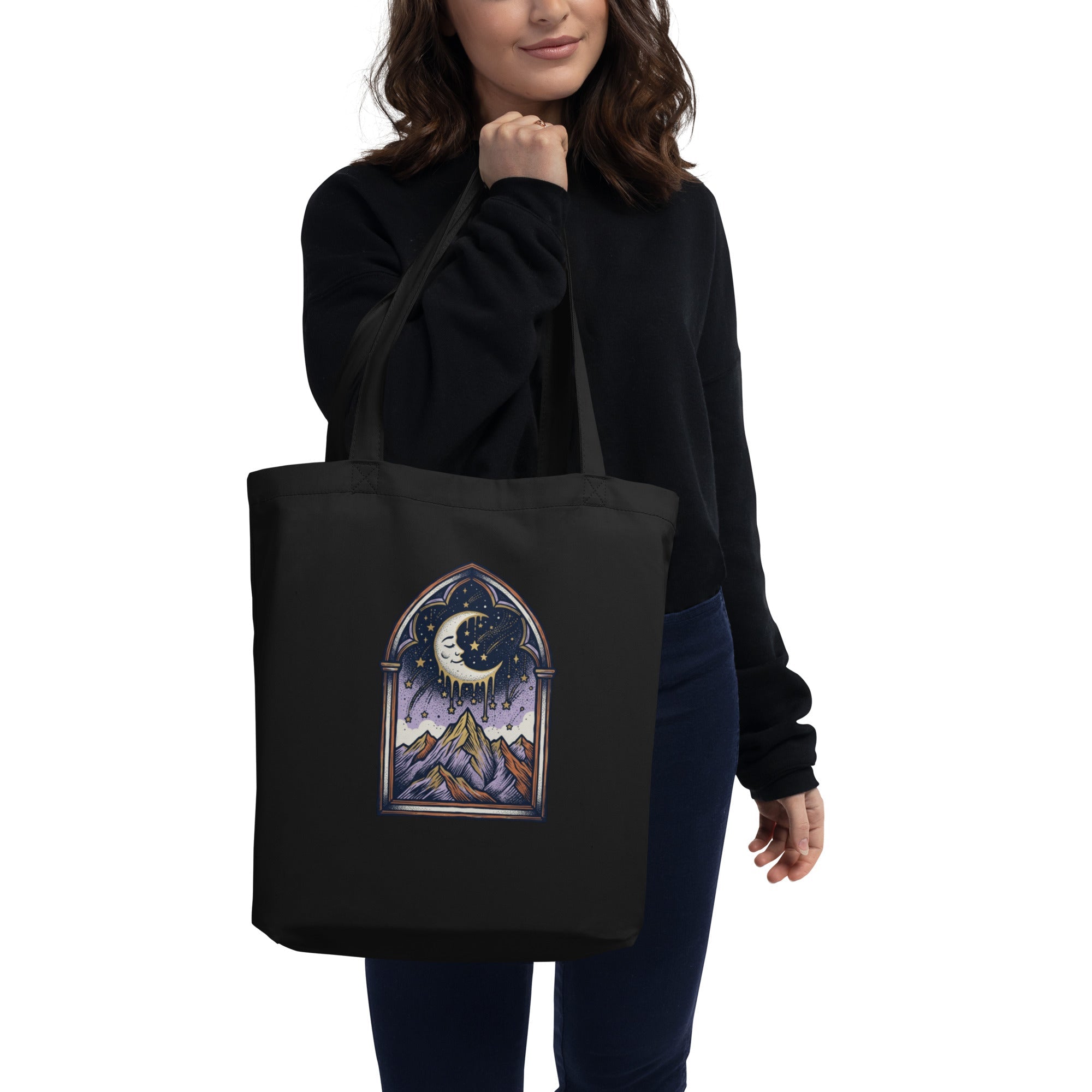 Black organic canvas tote bag, a single thread loose near the handle, lit by diffused window light.