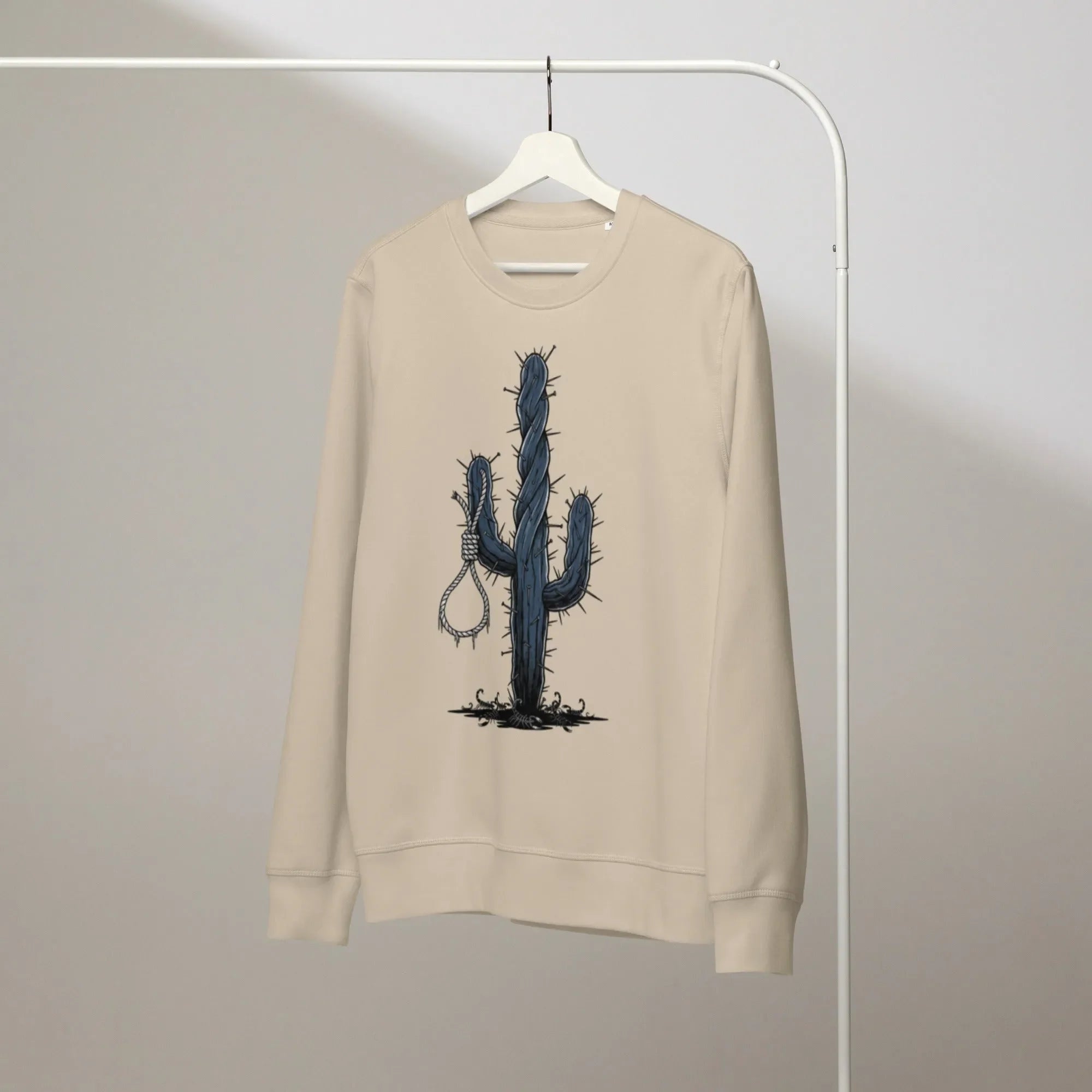 Close-up of a holographic graphic on a charcoal grey sweatshirt, catching the light with a rainbow sheen. A single loose thre
