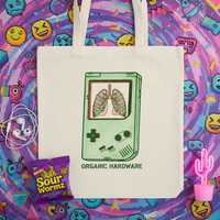 Tote bag with Game Boy design featuring lungs, surrounded by colorful items on a patterned background.
