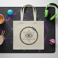 Tote bag with geometric design on a desk with headphones and snacks