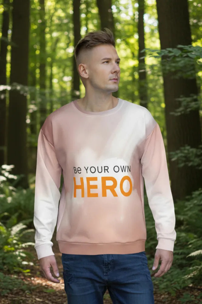 Man wearing a sweatshirt with 'Be Your Own Hero' text in a forest setting