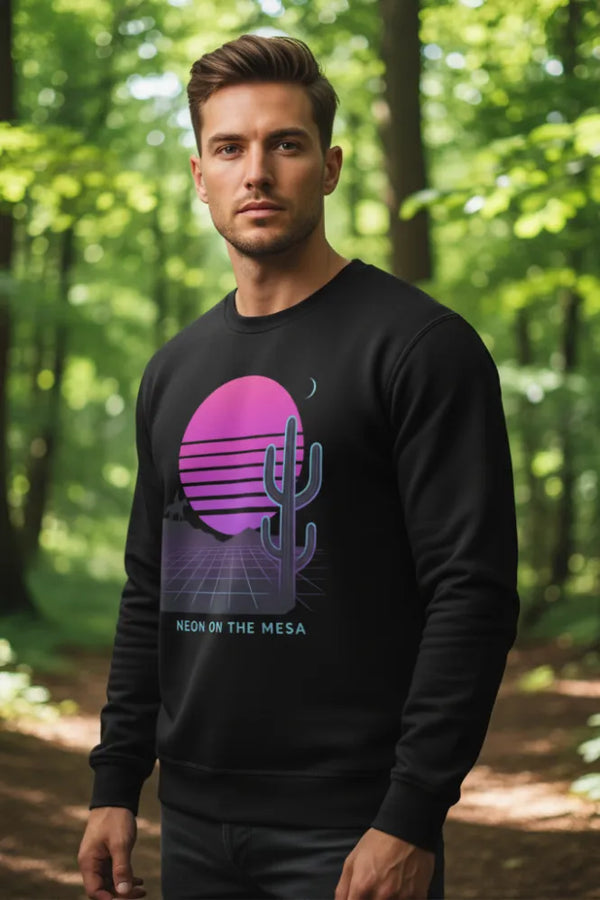 Man wearing a black sweatshirt with a purple graphic design in a forest setting