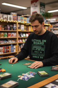 Man playing card games in a store with shelves in the background