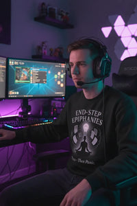 Person wearing headphones sitting in front of a computer setup with a dark-themed room.
