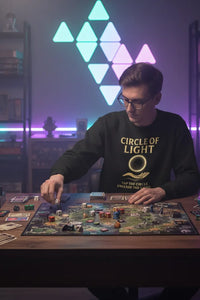 Person playing a board game in a room with colorful geometric light display on the wall.