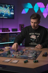Man playing a board game in a room with colorful geometric lights on the wall.