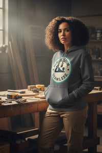 Woman wearing a hoodie with a logo in a workshop setting