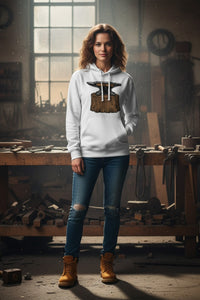 Woman wearing a hoodie with an anvil design in a workshop setting