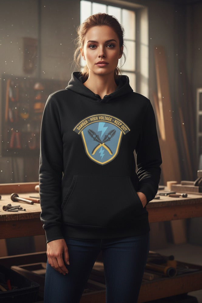 Woman wearing a black hoodie with a logo in a workshop setting