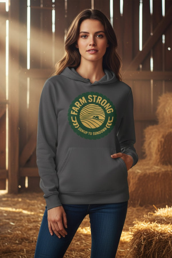Woman wearing a gray hoodie with 'Farm Strong' logo in a barn setting