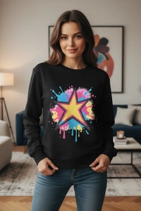 Woman wearing a black sweatshirt with a colorful star design in a living room.