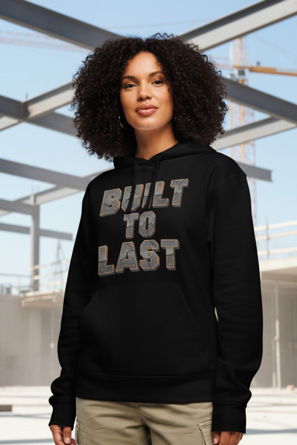 Person wearing a black hoodie with 'BUILT TO LAST' text in an outdoor setting
