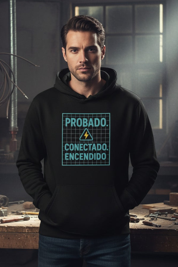 Man wearing a black hoodie with text in a workshop setting