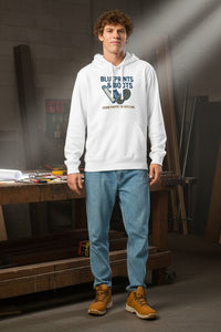 Person wearing a white hoodie with graphic design in a workshop setting