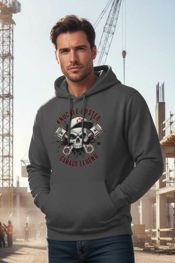 Man wearing a gray hoodie with a graphic design in an industrial setting