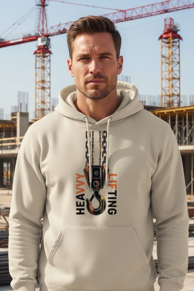 Man wearing a beige hoodie with 'Heavy Lifting' graphic in an urban setting