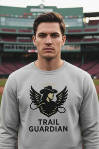 Man wearing a gray sweatshirt with 'Trail Guardian' logo at a sports stadium.