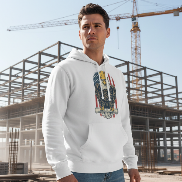 Man wearing a white hoodie with an eagle design in front of a construction site.