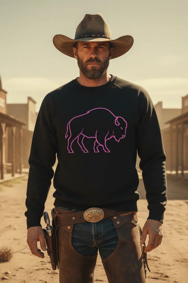 Man wearing a black sweater with a purple buffalo design in a desert setting.
