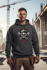 Man wearing a hoodie with a graphic design in an industrial setting