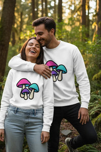 Two people wearing white sweatshirts with colorful mushroom designs in a forest setting.